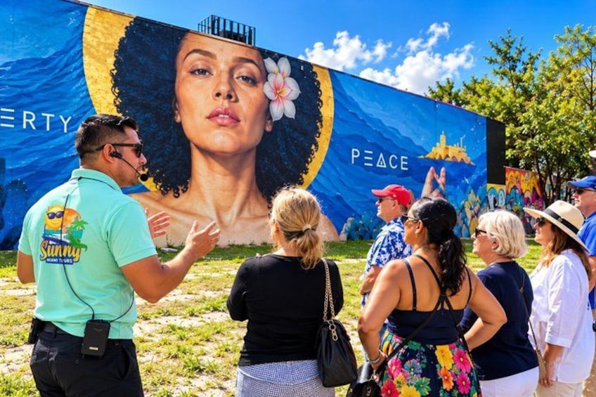 A mural with a woman, the word 'PEACE,' and a cityscape. 2