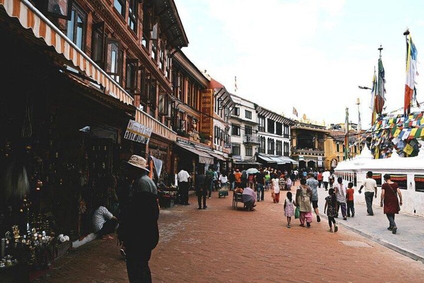 A bustling street market with people shopping and walking. 2