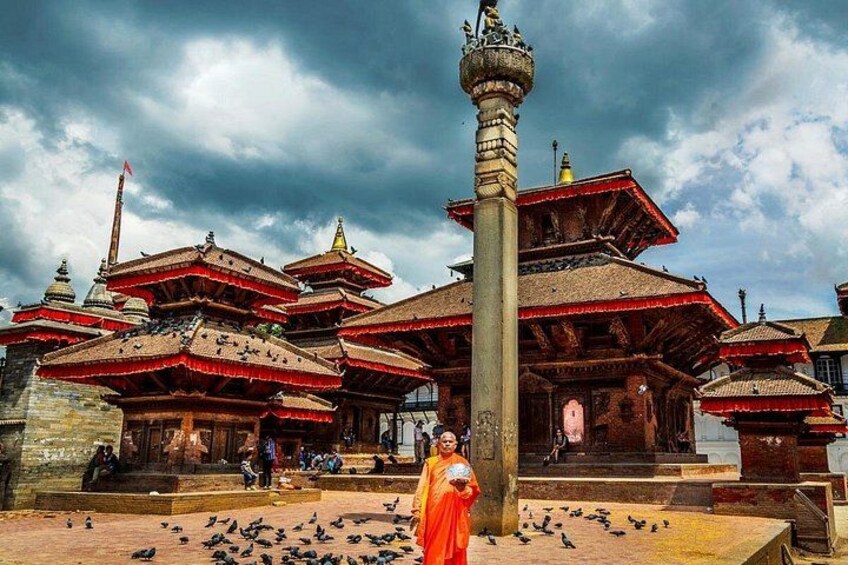 A traditional multi-tiered temple with a central spire, surrounded by a courtyard with pigeons. 5