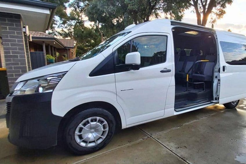 A white van parked on a driveway with its door open, revealing the interior. 5