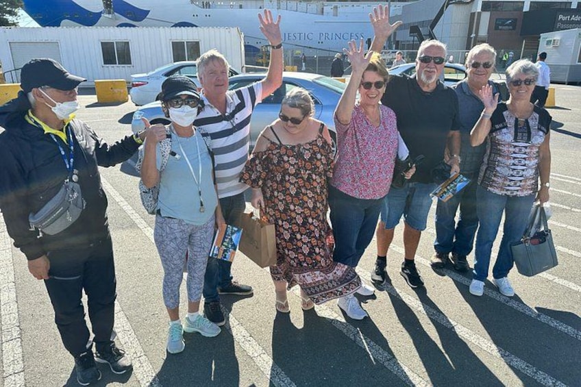 A group of people posing for a photo in an airport. 4