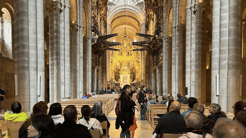 A cathedral interior with high vaulted ceilings, large columns, and a central altar. 3