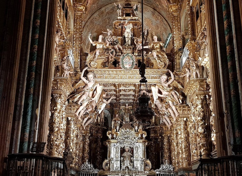 An ornate golden altar with religious statues and carvings. 5