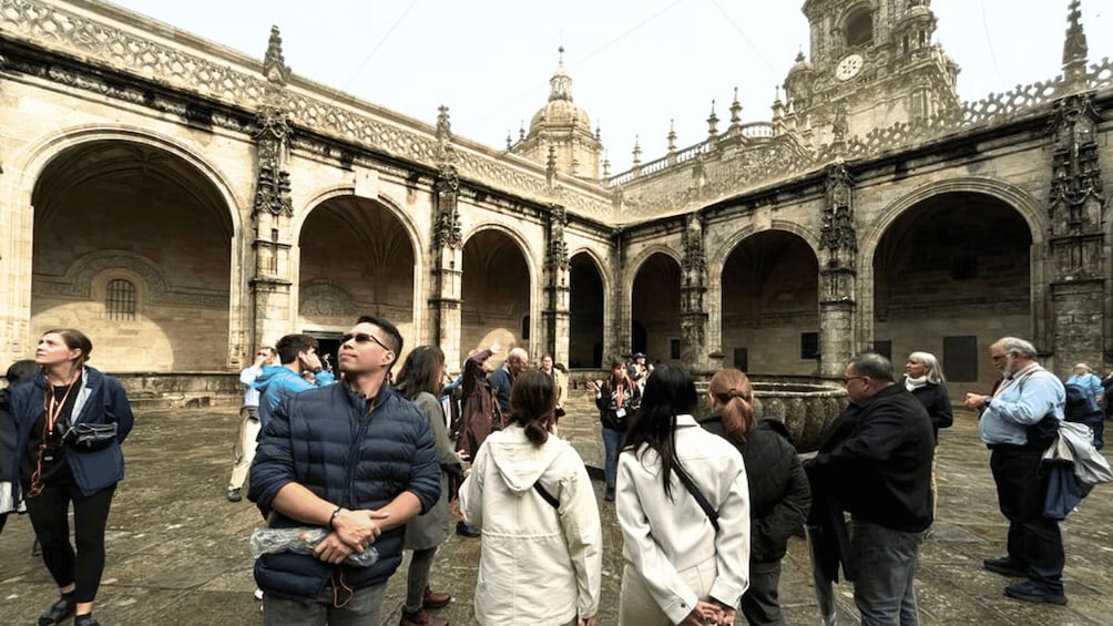 A historic courtyard with arches and ornate architecture. 2