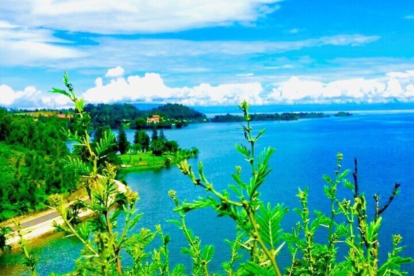 A lake surrounded by greenery and a distant shoreline. 4