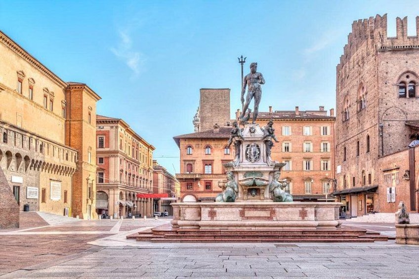 Ein historischer Platz mit einem zentralen Brunnen, umgeben von klassischer Architektur. 1