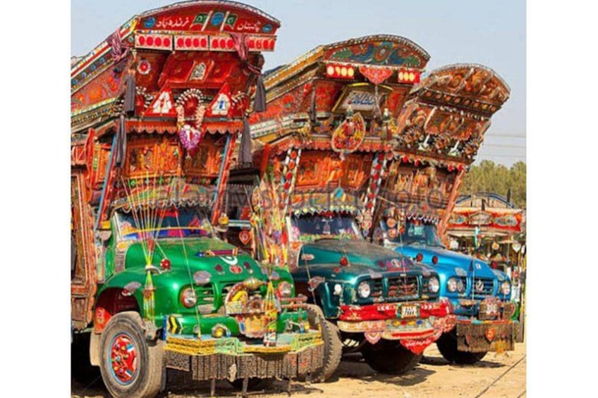 Three heavily decorated trucks parked in a row. 3