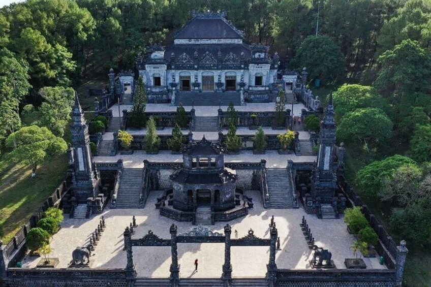 An aerial view of a temple complex with a central courtyard, surrounded by lush greenery. 4
