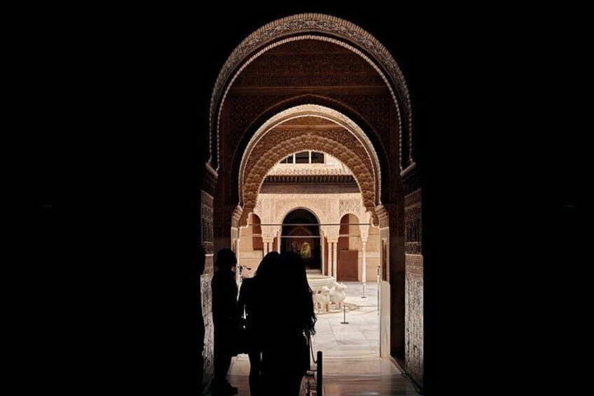 Silhouette in arched doorway
Step into a portal of history—arched doorways framing Alhambra’s enduring grandeur against the Andalusian sky. 2