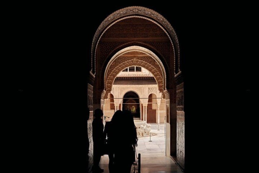 Silhouette in arched doorway
Step into a portal of history—arched doorways framing Alhambra’s enduring grandeur against the Andalusian sky. 2