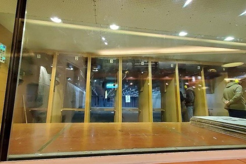 A glass door with numbered panels, a person in a green jacket, and a reflection of an interior space. 2