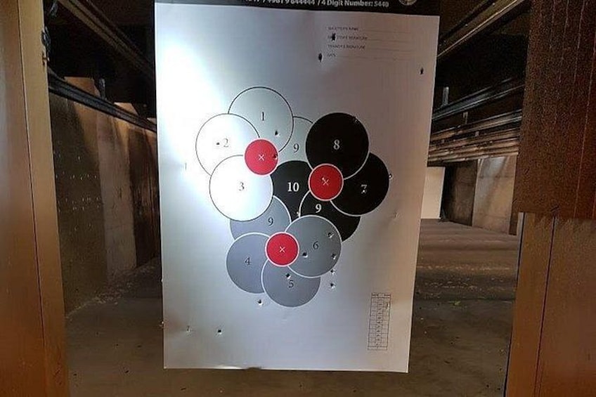 A target board with numbered circles and red X marks. 3