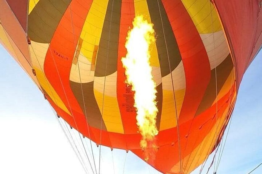 A hot air balloon with a flame on its basket. 3