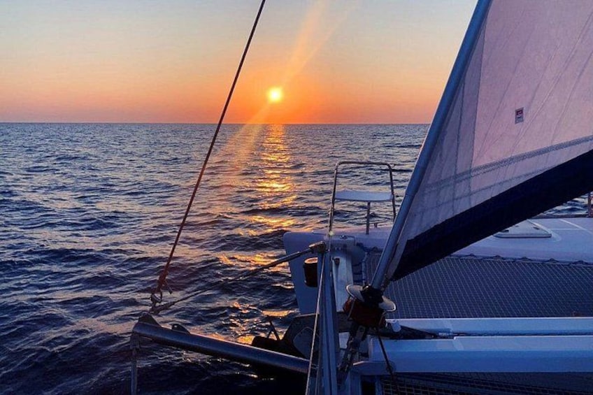 A sailboat at sunset with the sun reflecting on the water. 2