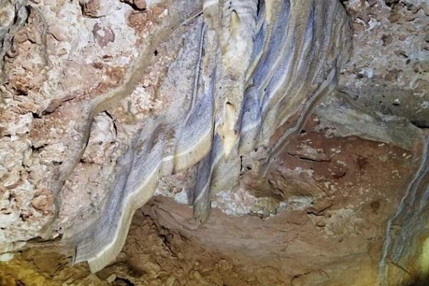 A cave interior with stalactites and stalagmites. 2