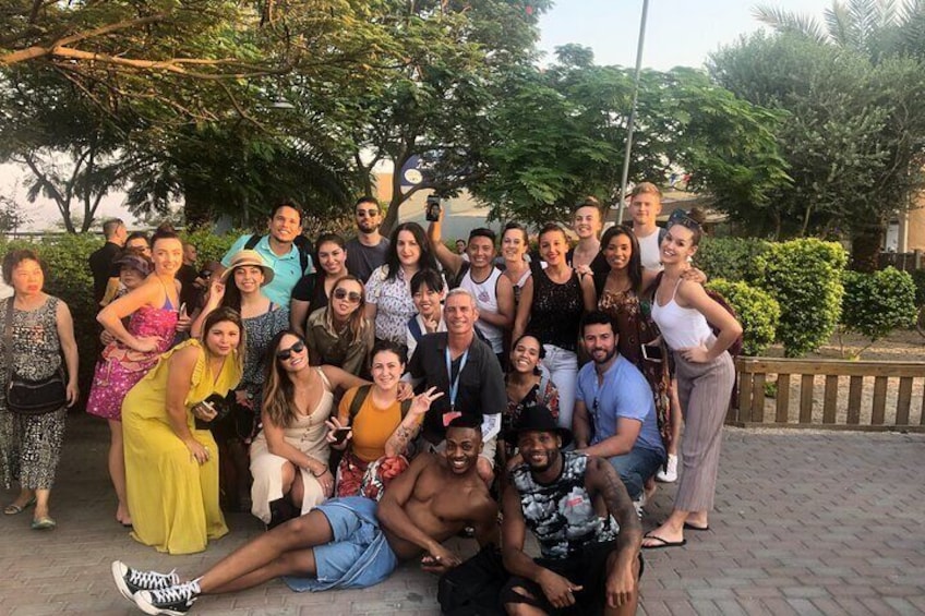 A group of people posing for a photo outdoors. 4