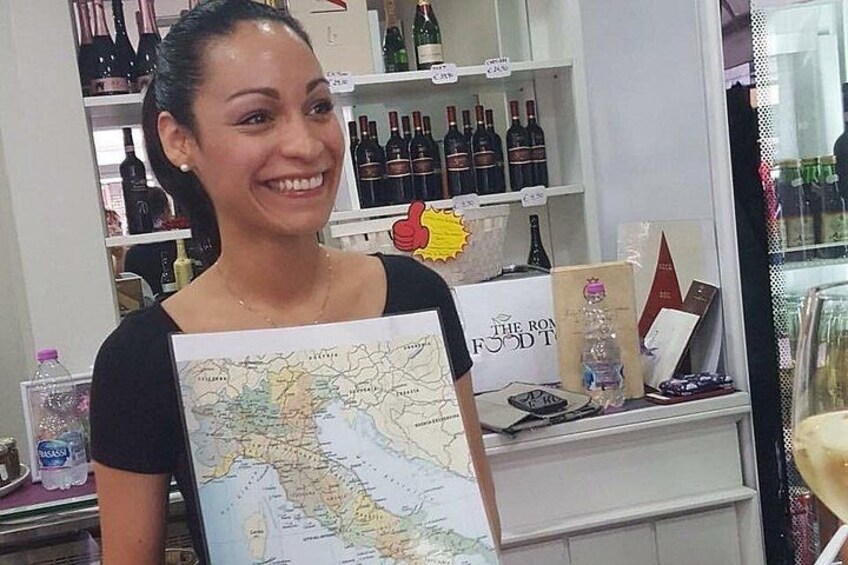 A person holding a map in a store with shelves of wine bottles. 2