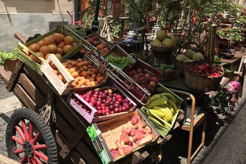 A fruit cart with various fruits like apples, bananas, and oranges. 5