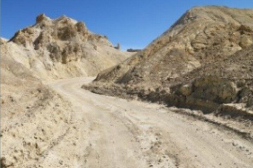 A desert landscape with a winding dirt road. 3