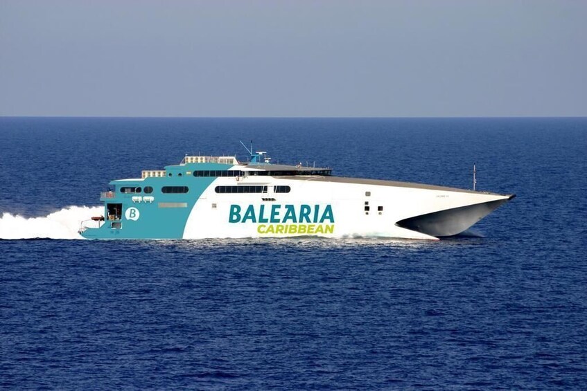 A large yacht named 'BALEARIA CARIBBEAN' cruising on the ocean. 4