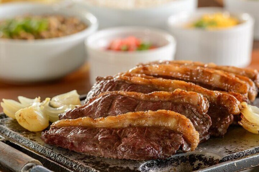 Grilled pork belly with garlic and onions on a plate. 2