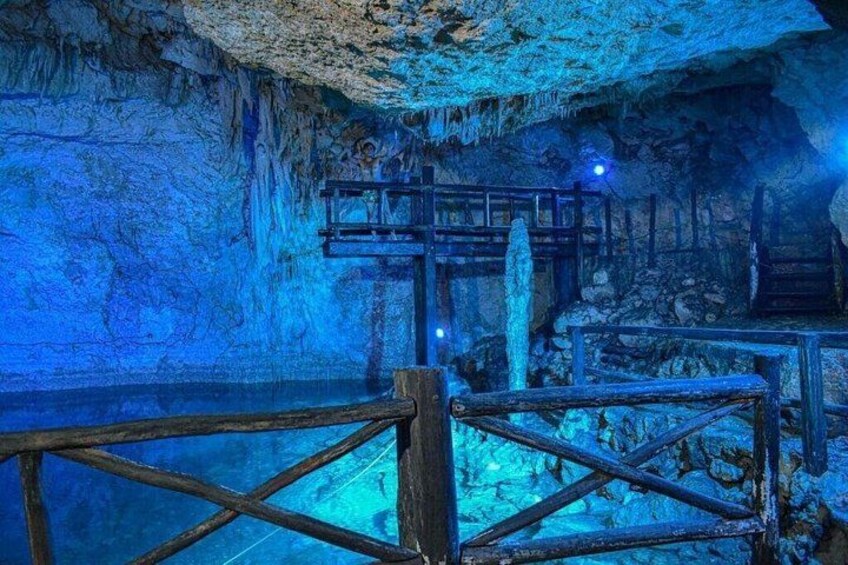 An underground cave with wooden railings and stalactites. 2