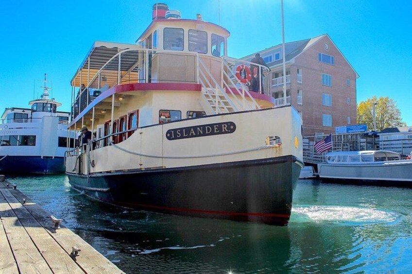 Un barco llamado 'ISLANDER' atracado en un muelle, con un edificio al fondo. 2