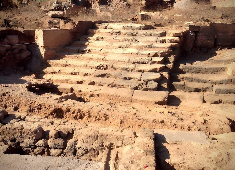 Ancient stone steps leading up to a structure. 5