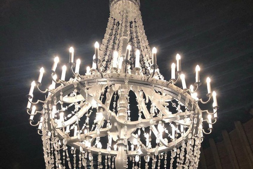 Un grande e elaborato lampadario con numerose luci a forma di candela. 3