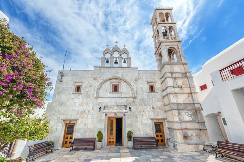 A historic church with a bell tower, arched windows, and a central doorway. 5
