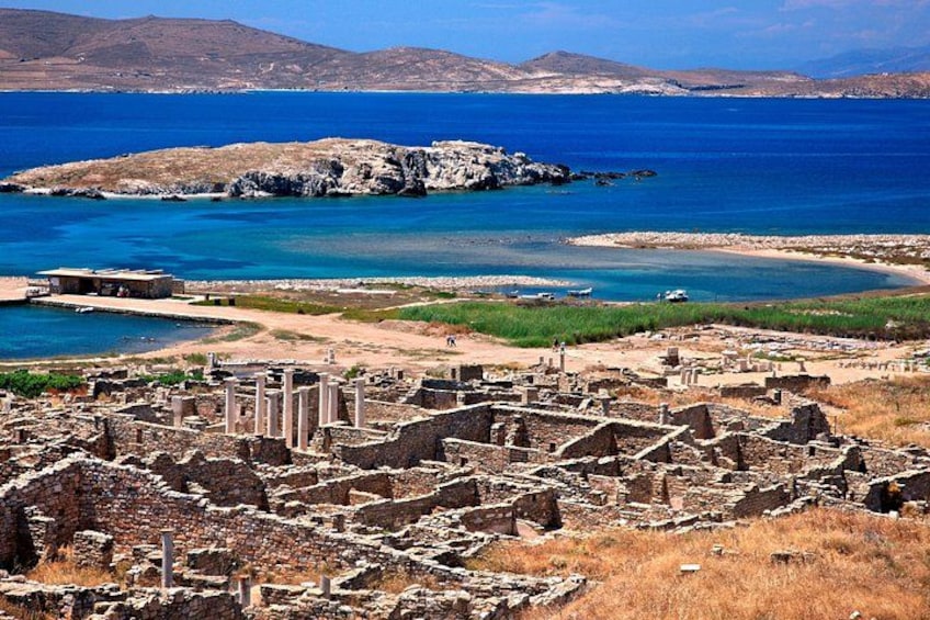 Ancient ruins, a coastal landscape, and a distant island. 2
