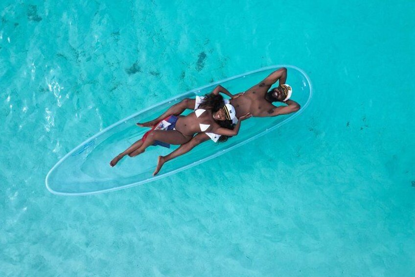 A person lying on a surfboard in a clear blue pool. 1