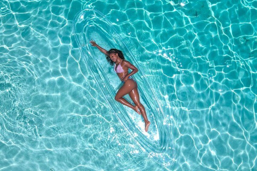 A person swimming in a clear blue pool. 3