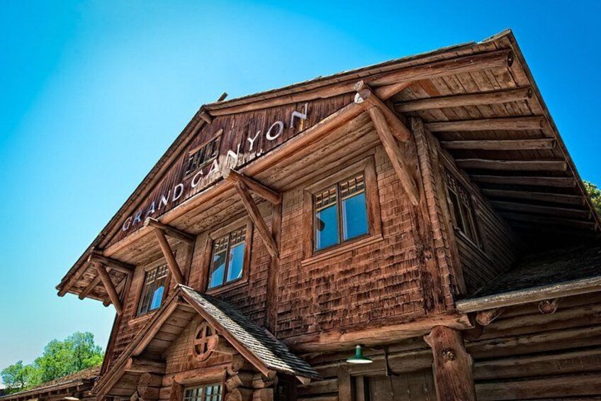 A wooden building with a sign that reads 'Grand Canyon.' 4
