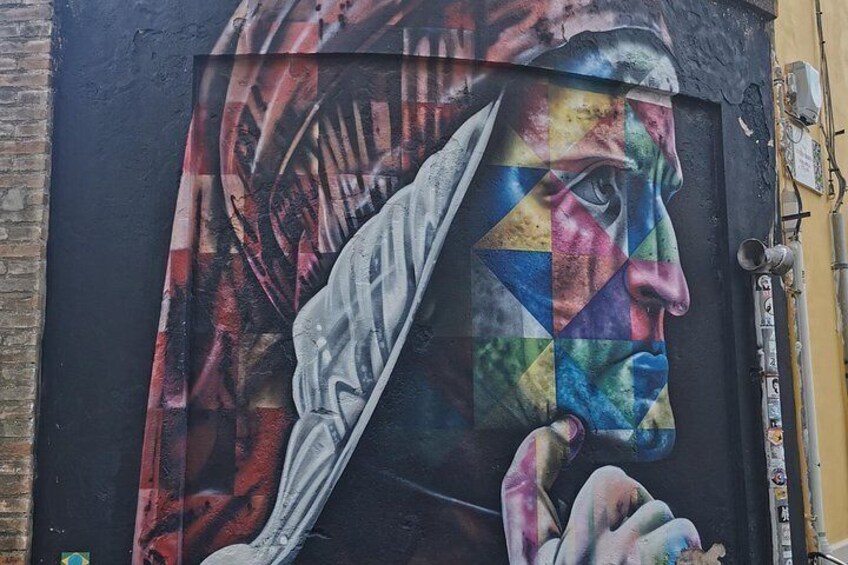 A mural with a geometric pattern and a partial view of a person's face. 3