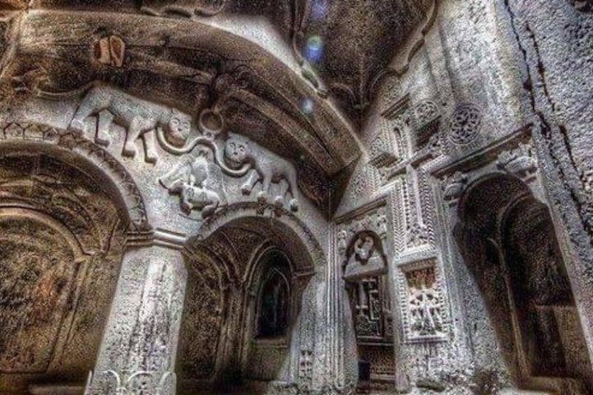 Intricate stone carvings and arches in an ancient structure. 3