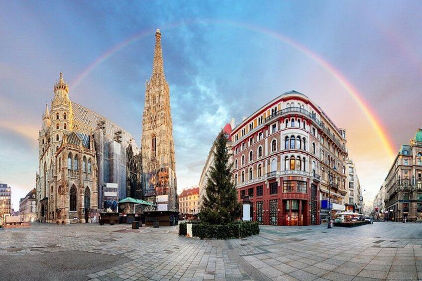 A cathedral, a tall building, and a curved building with a rainbow in the background. 3