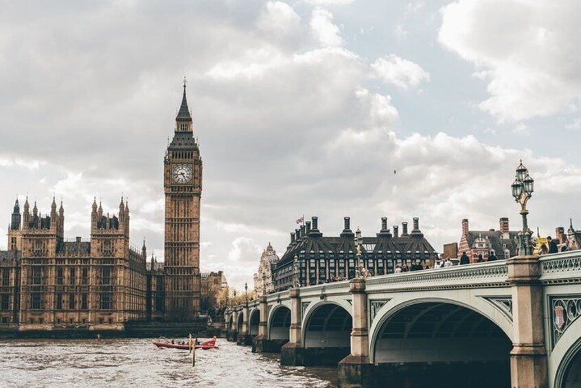 The Houses of Parliament and Big Ben in London, with a river and a bridge in the foreground. 1
