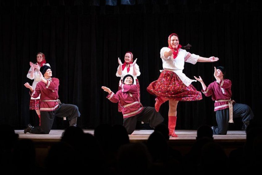A stage with performers in traditional costumes. 5