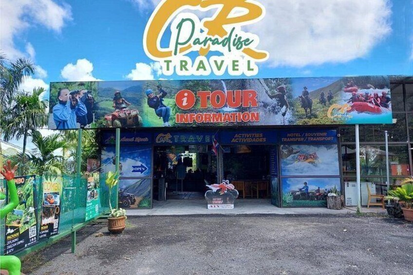 A travel agency named Paradise Travel with a signboard and entrance. 3