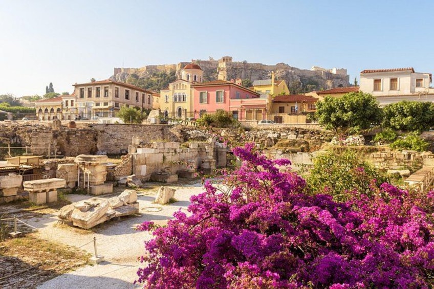 Ancient ruins, colorful buildings, and purple bougainvillea in a historic town. 1