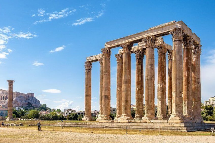Ancient Greek columns, a clear sky, and a distant view of a historical building. 2