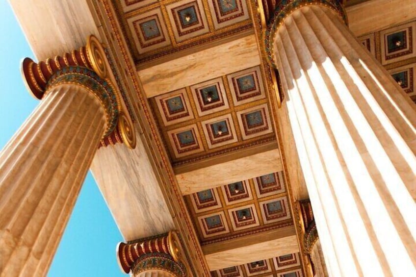 A close-up of classical columns with ornate capitals and a patterned ceiling. 5