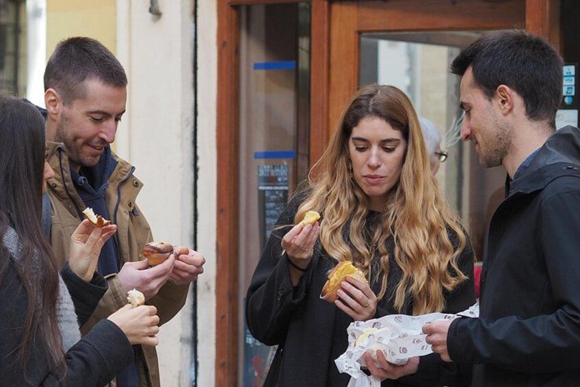 Four people eating food outdoors. 3