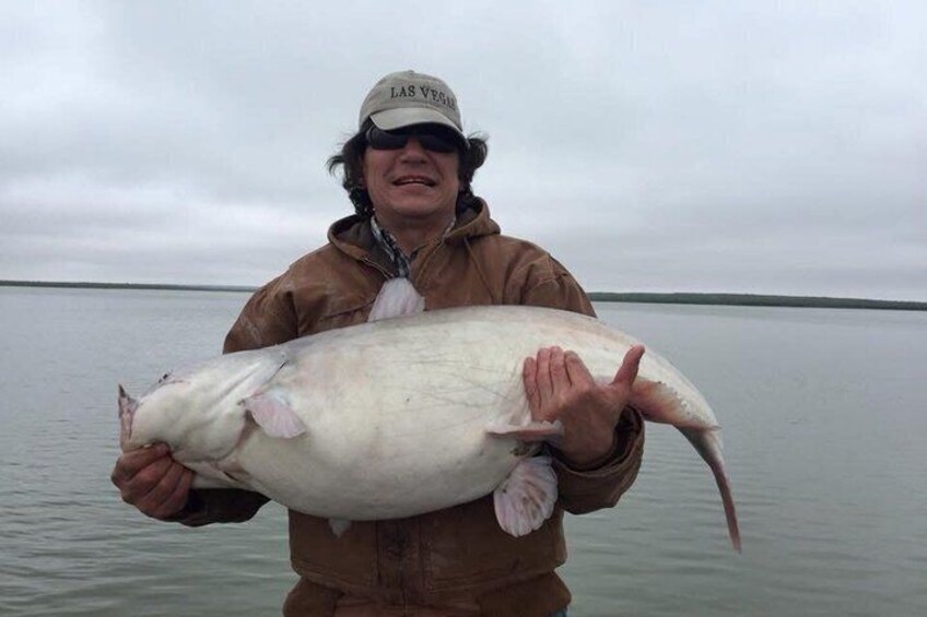 A person holding a large fish. 3