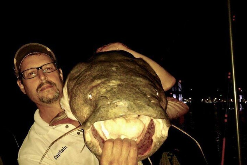 A person holding a large fish. 1
