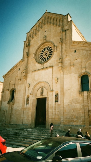A historic church with a large circular window and a bell tower. 5