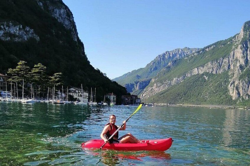 A person kayaking on a calm lake surrounded by mountains. 2