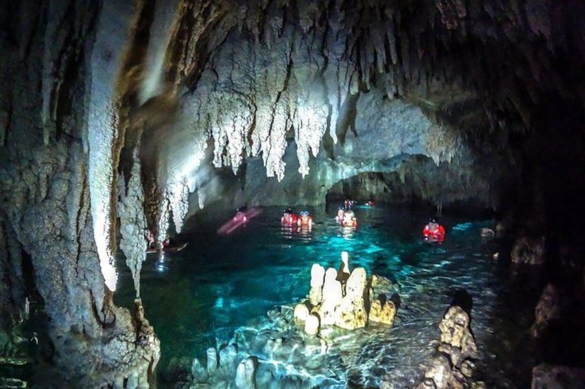 A cave with stalactites and a pool of water. 4