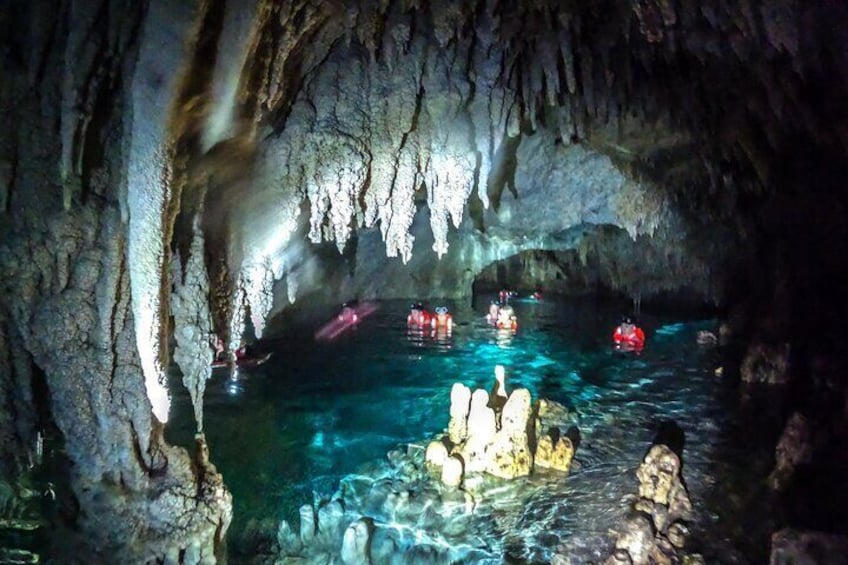 A cave with stalactites and a pool of water. 2